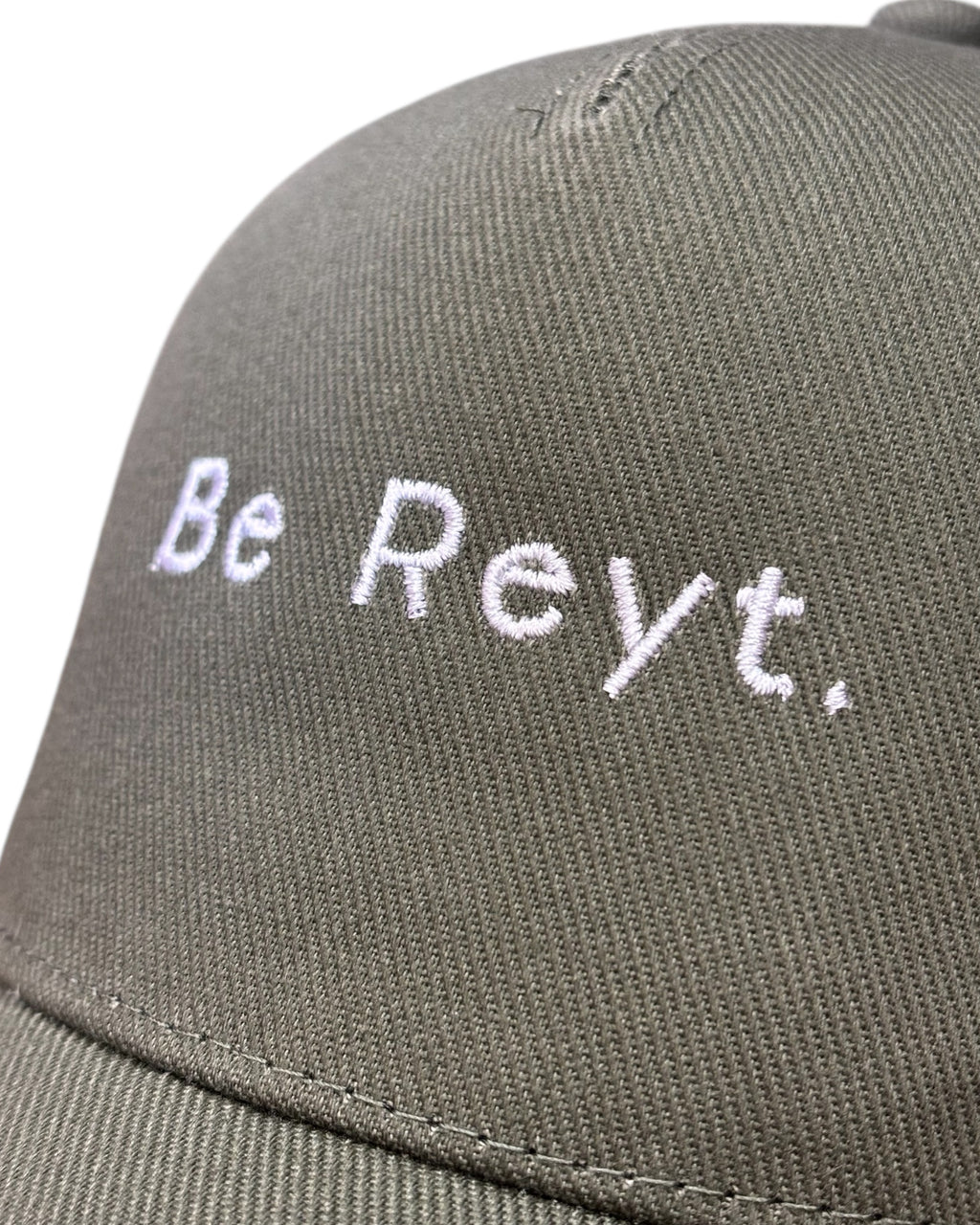 Close up view of the front stitching on a dad cap with minimalist funny Yorkshire / Northern / Lancashire slogan / logo in embroidery/ embroidered. This hat would be a perfect gift for a Northerner. Suitable for men and women, it's unisex and great quality. Be reyt. Yorkshire dialect.