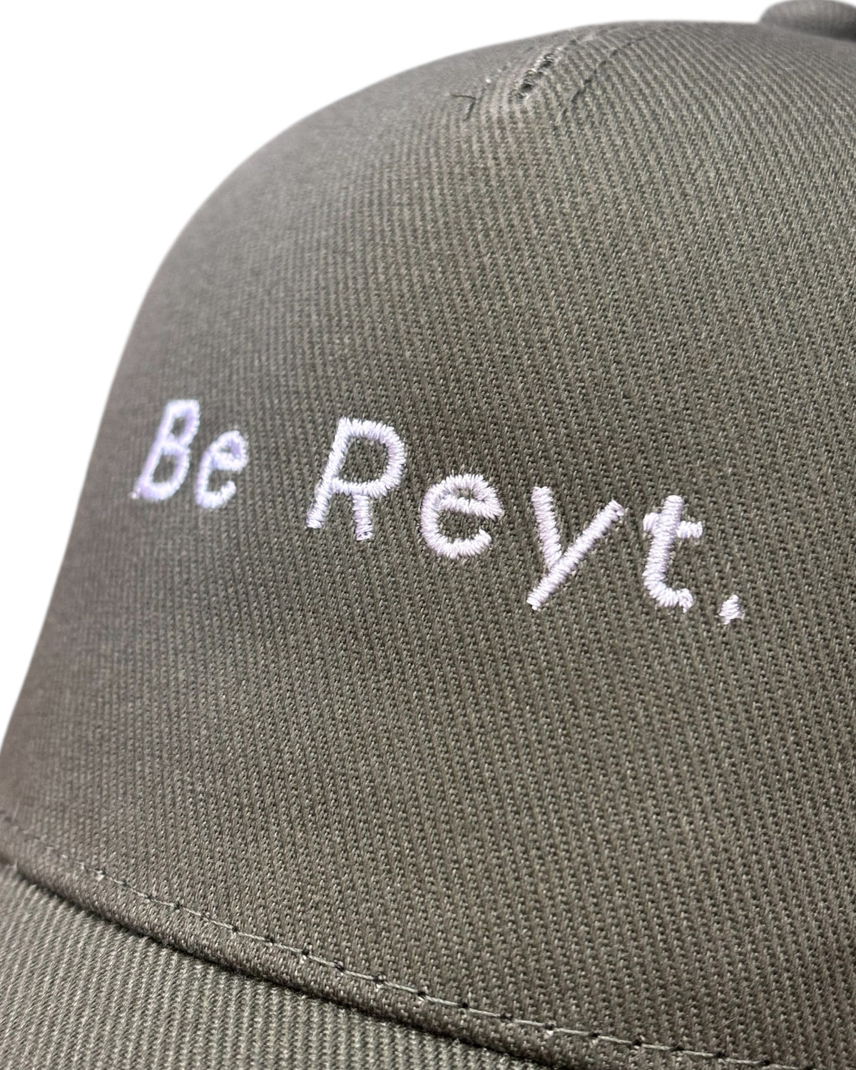 Close up view of the front stitching on a dad cap with minimalist funny Yorkshire / Northern / Lancashire slogan / logo in embroidery/ embroidered. This hat would be a perfect gift for a Northerner. Suitable for men and women, it's unisex and great quality. Be reyt. Yorkshire dialect.