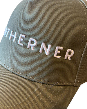 Close up of stitching on olive khaki green dad cap with white Northerner embroidery / embroidered slogan logo. Hat for men and women - unisex. Great gift for someone from Yorkshire or Lancashire. 