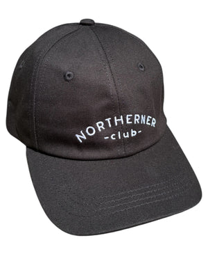 Close up shot of the stitching detail on a black neutral dad cap with white Northerner embroidery / embroidered sports club type slogan logo. Hat for men and women - unisex. Great gift for someone from Yorkshire or Lancashire.
