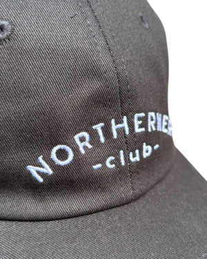 Close up shot of the stitching detail on a black neutral dad cap with white Northerner embroidery / embroidered sports club type slogan logo. Hat for men and women - unisex. Great gift for someone from Yorkshire or Lancashire.