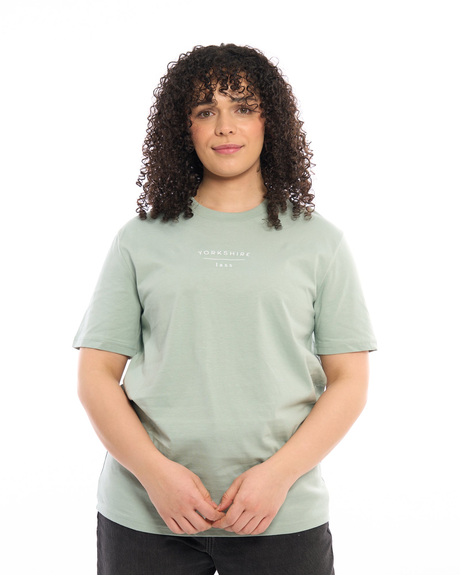 Female model wearing Yorkshire lass light cream white neutral t-shirt, with black embroidered slogan / logo. 100% organic cotton premium heavy thick quality t-shirt top. Minimalist design. Northern clothing. Women's unisex t-shirt