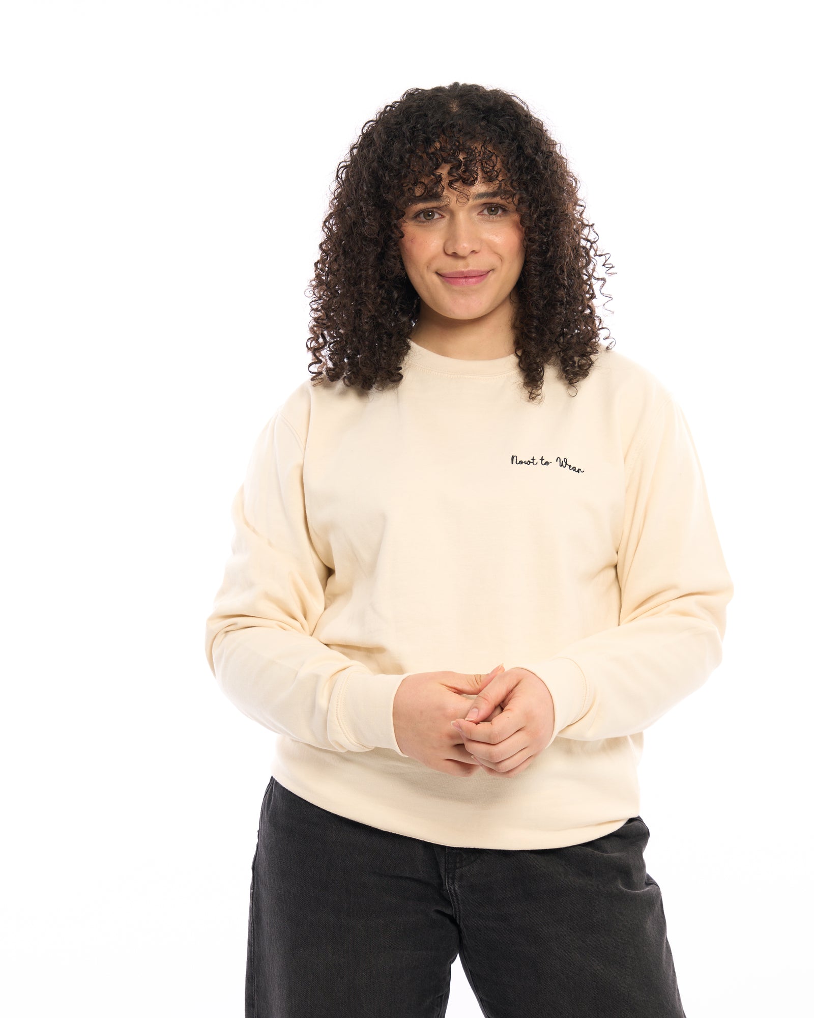 Premium quality designer embroidered embroidery Nowt to Wear (nothing to wear) funny slogan logo crew neck long sleeve sweatshirt. Turquoise teal blue green top with subtle handwriting white minimalist small logo on the left breast. Yorkshire Lancashire dialect. Funny local slogan logo dialect. Men's and women's clothing - unisex wear. Male model with hand in pocket looking to the right.