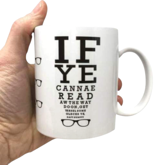 LighthouseLane white ceramic mug featuring a funny Scottish eye test chart design with black text and glasses icons.