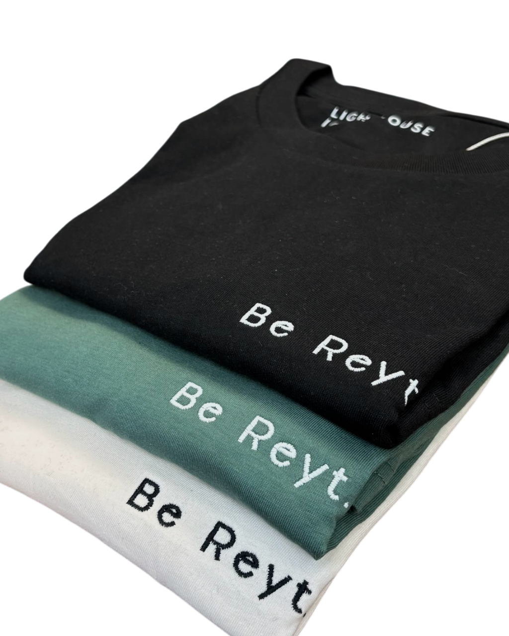 LighthouseLane organic cotton t-shirts in black, green, and white with Be Reyt Yorkshire slogan embroidery