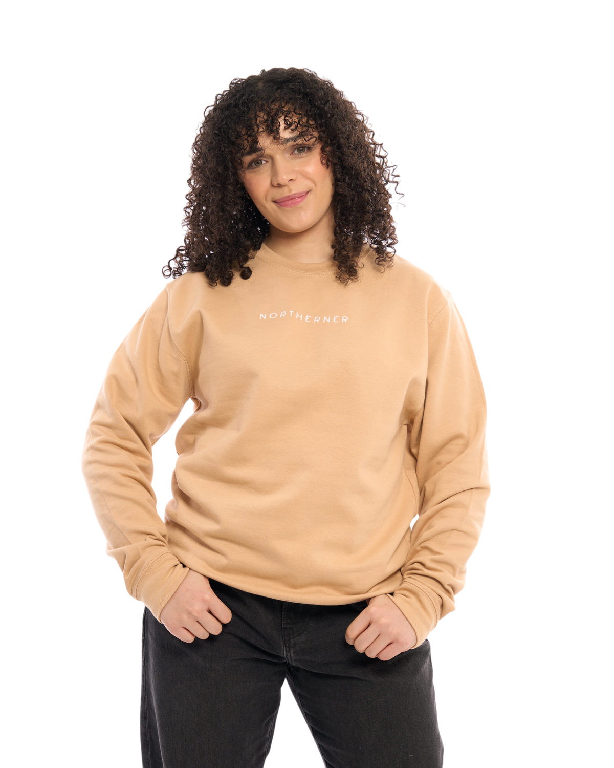 LighthouseLane unisex beige sweatshirt with Northerner embroidery worn by a woman with curly hair on white background