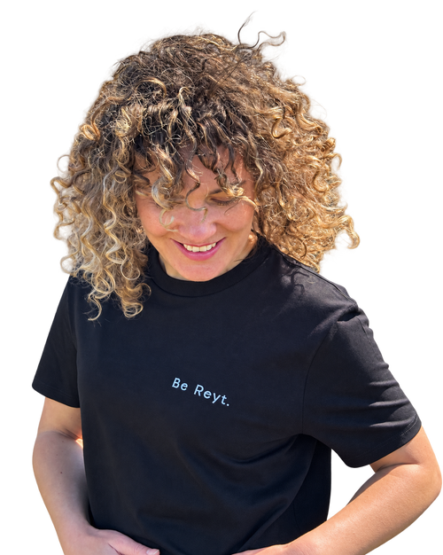 LighthouseLane black organic cotton unisex t-shirt with Be Reyt embroidered slogan worn by a woman with curly hair