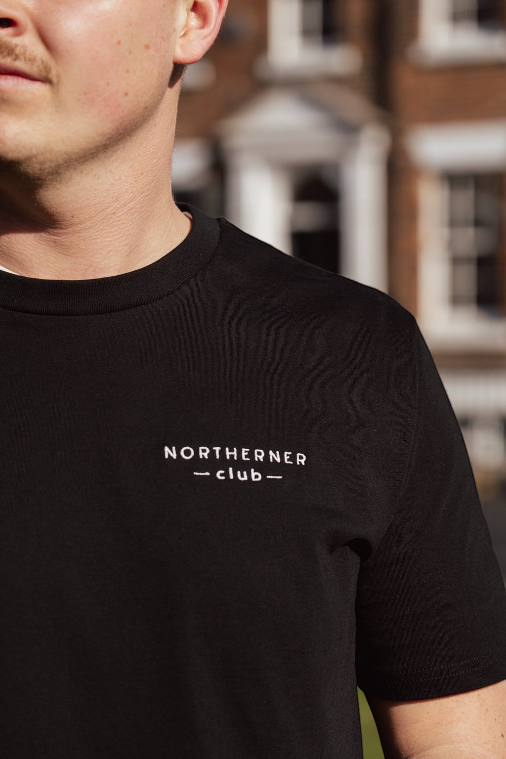 LighthouseLane black organic cotton unisex t-shirt with Northerner Club embroidered slogan on the chest
