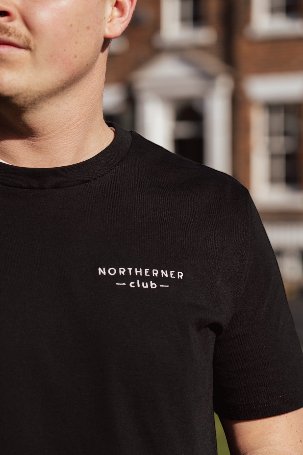 LighthouseLane black organic cotton unisex t-shirt with Northerner Club embroidered slogan on the chest