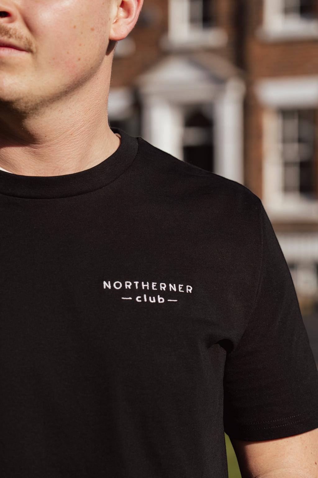LighthouseLane black organic cotton unisex t-shirt with Northerner Club embroidered slogan on the chest