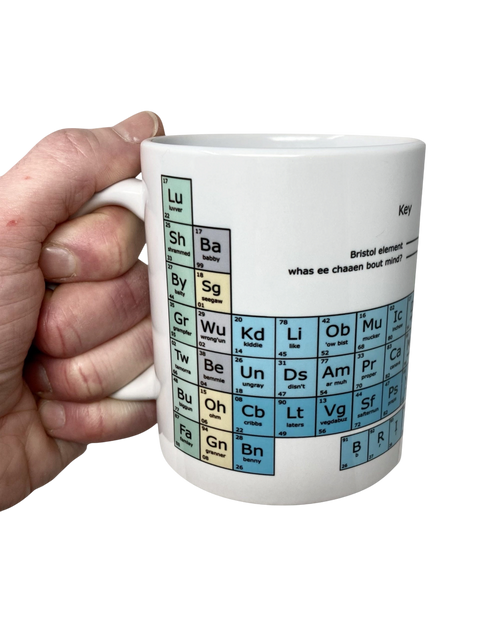 LighthouseLane white ceramic mug featuring a colorful Bristolian dialect periodic table design held in a hand.