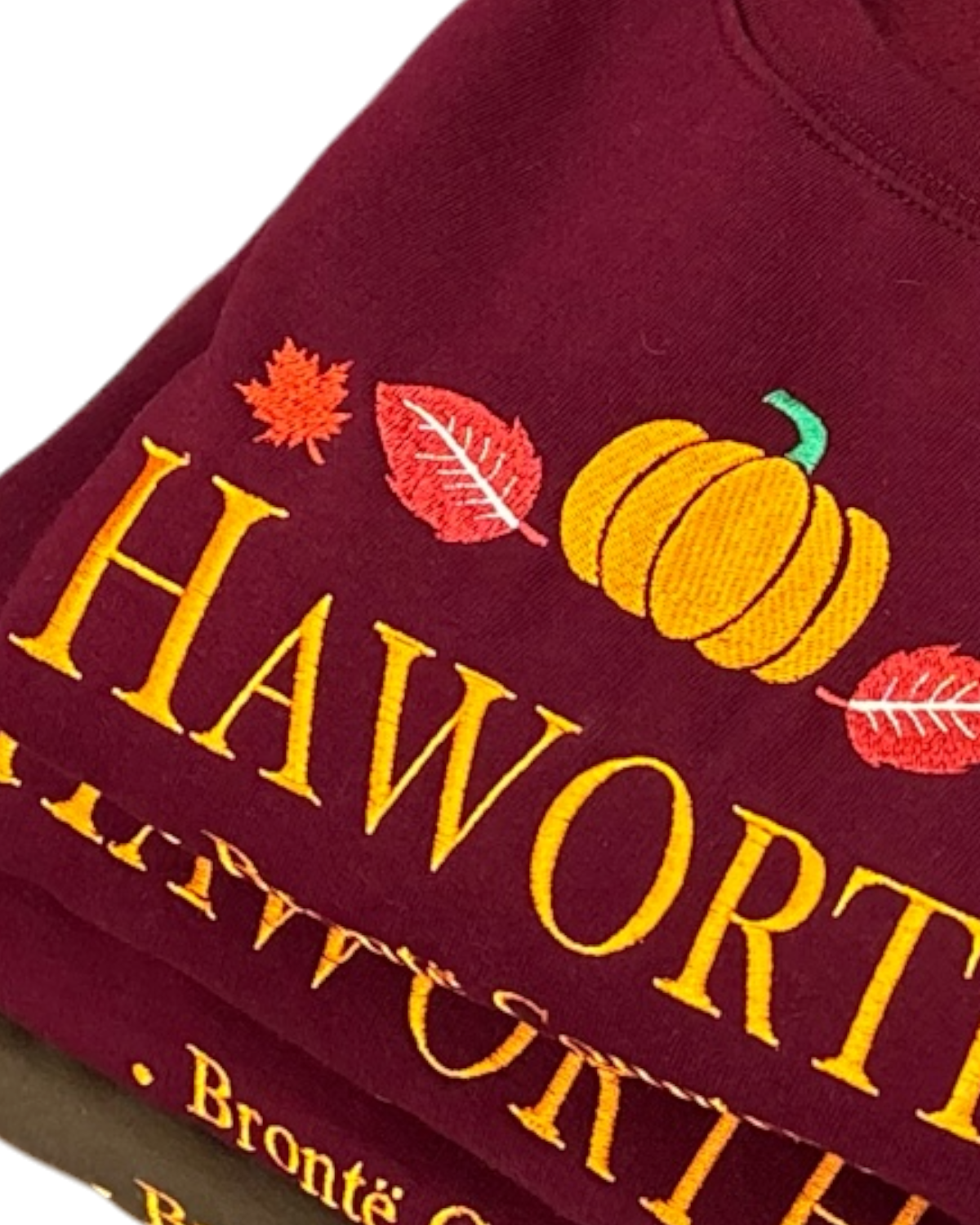 LighthouseLane burgundy sweatshirt with embroidered Haworth lettering, autumn leaves, and a pumpkin design.