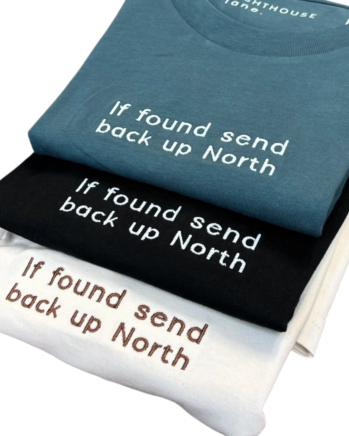 LighthouseLane organic cotton T-shirts in blue, black, and white with If Found Send Up North embroidered slogans.