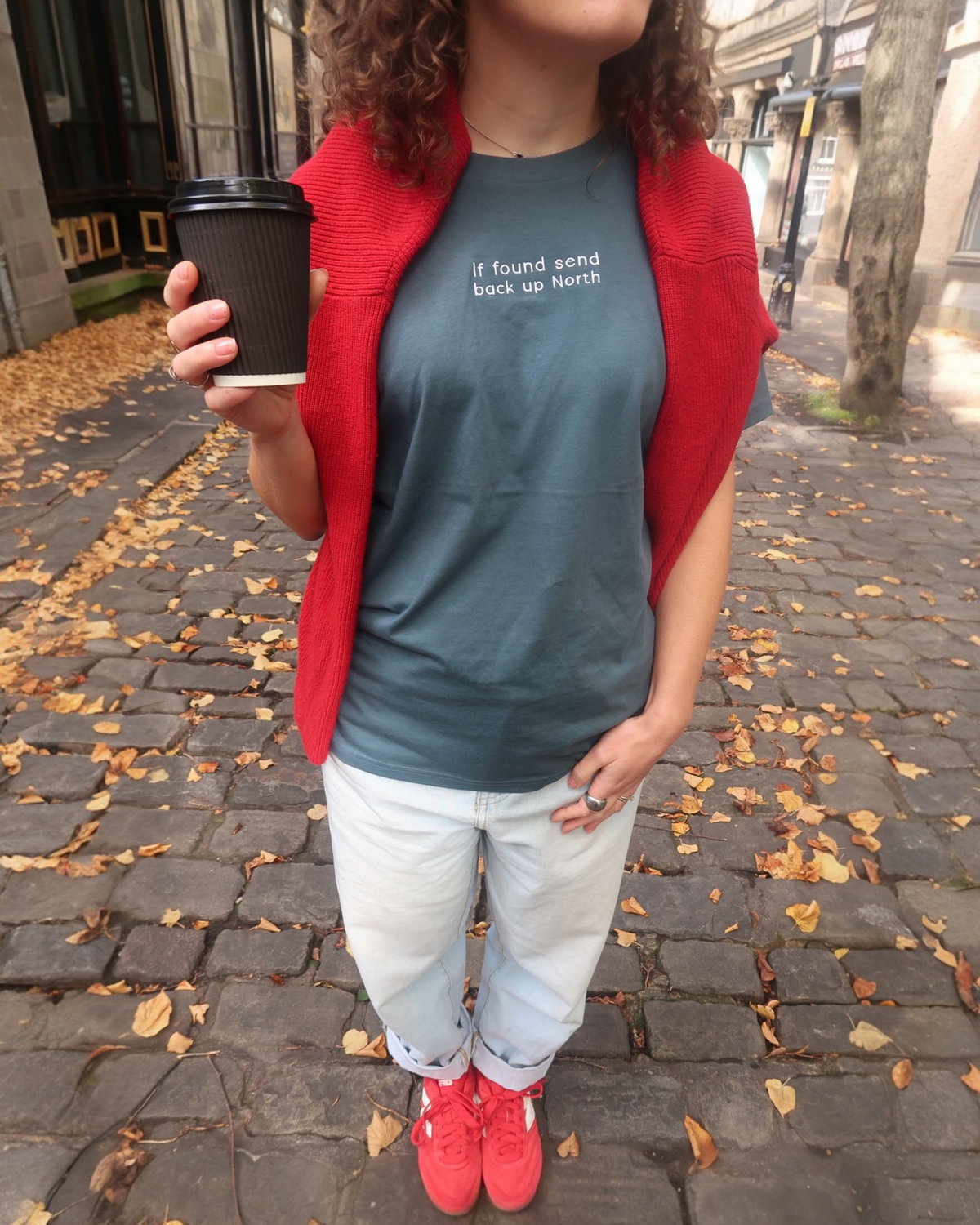LighthouseLane unisex organic cotton t-shirt in dark grey with If Found Send Up North embroidery, worn with red sweater