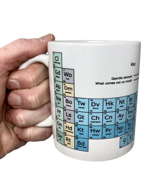 LighthouseLane white ceramic mug featuring a colourful Geordie dialect periodic table design held in a hand.
