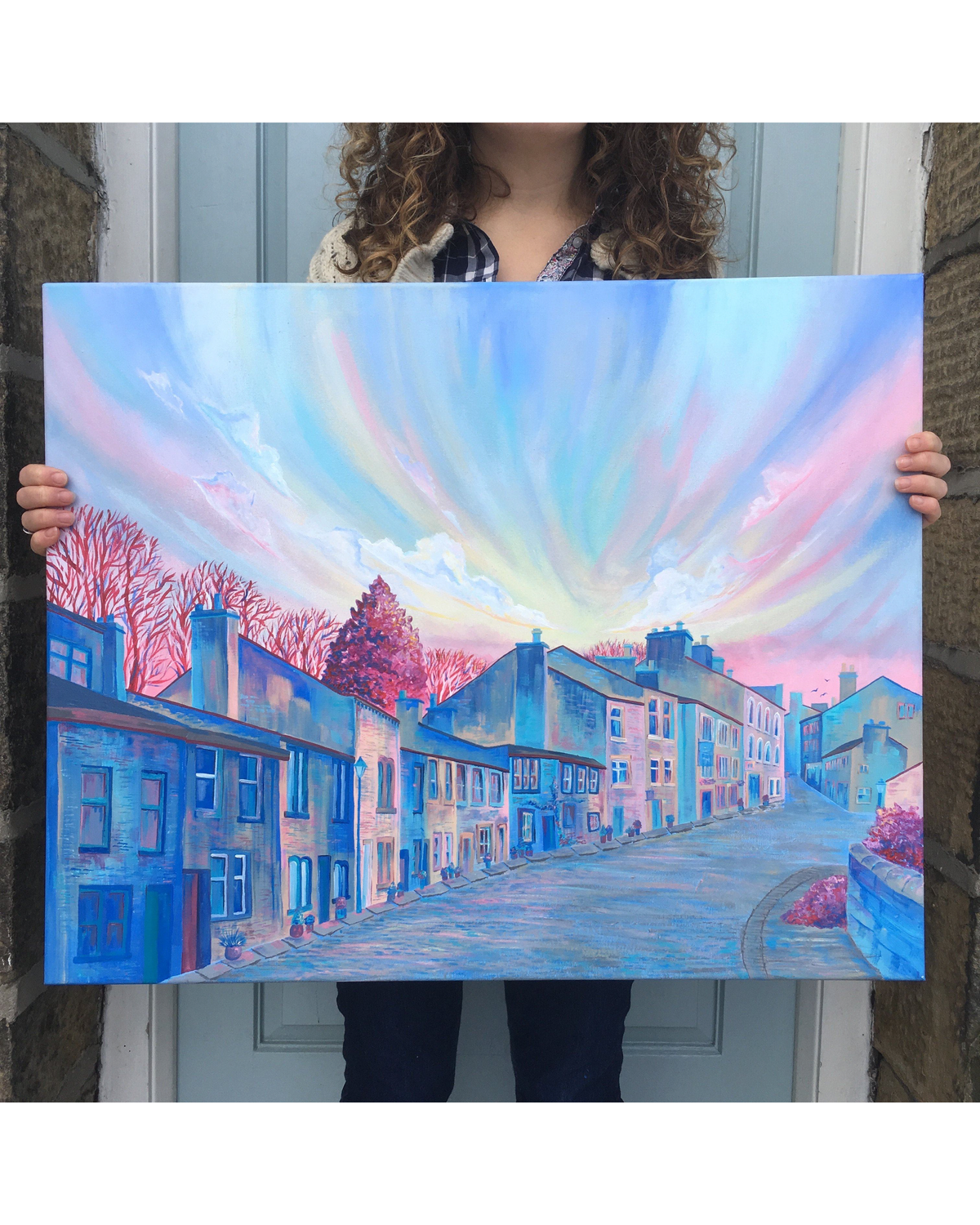 LighthouseLane Haworth Main Street landscape painting featuring a vibrant pink and blue sunset over a Yorkshire village.