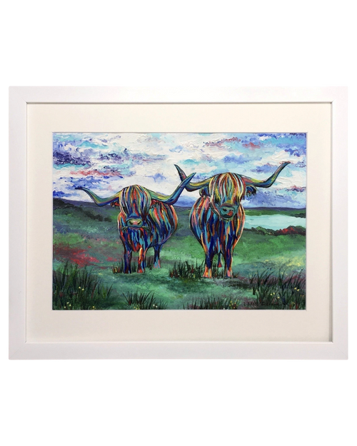 LighthouseLane framed art print featuring two colourful hand-painted highland cows in a vibrant Scottish landscape