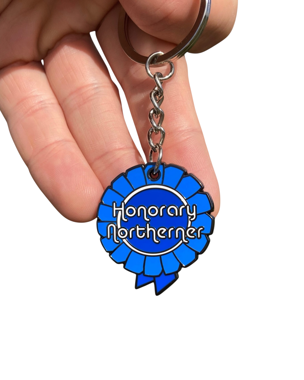 LighthouseLane Honorary Northerner blue enamel rosette keyring held in a hand against a white background