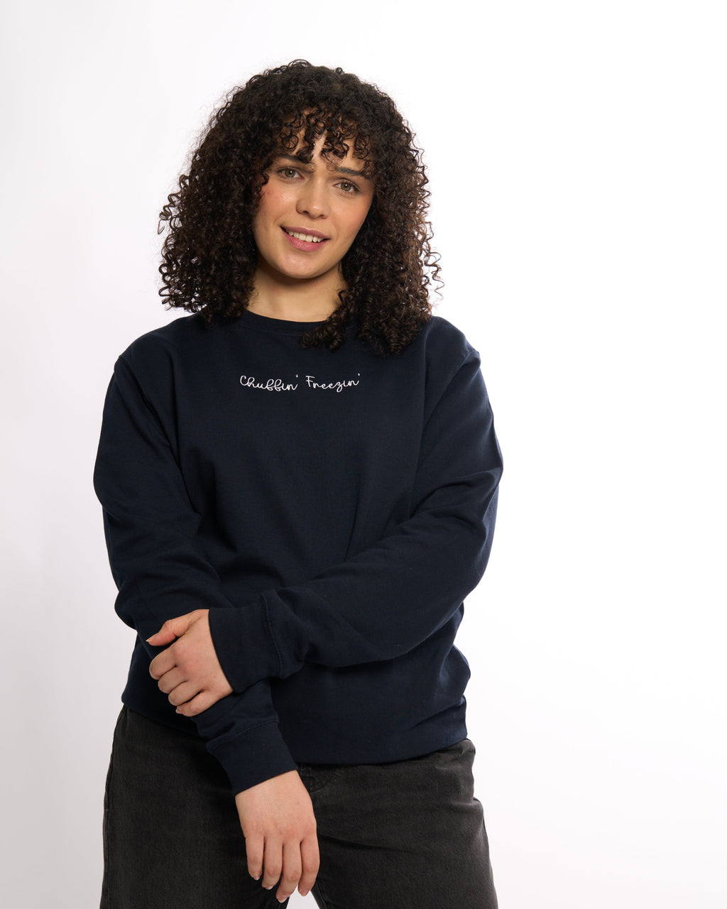 LighthouseLane navy blue unisex sweatshirt with Chuffin Freezin embroidered slogan worn by a woman with curly hair