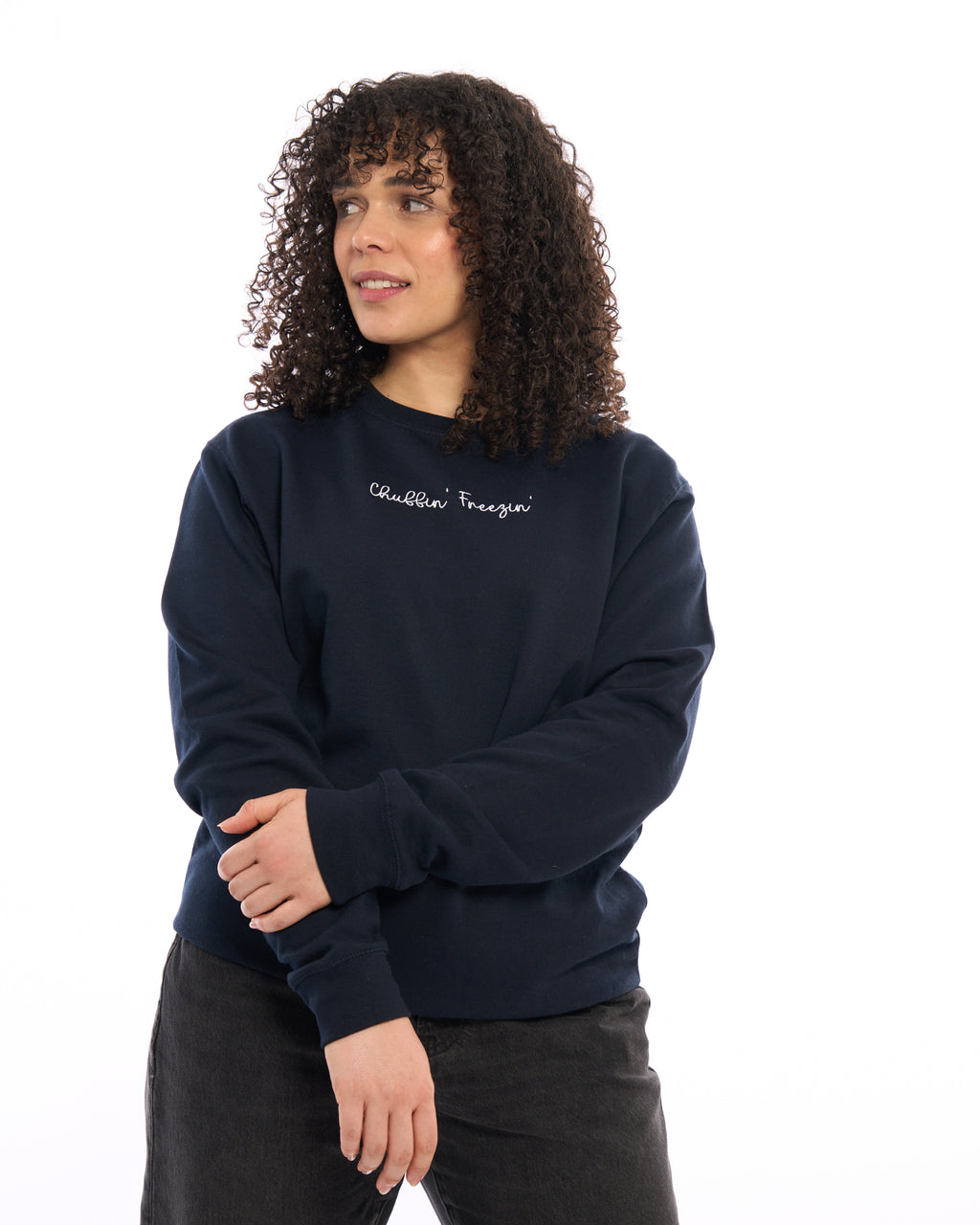 LighthouseLane navy blue unisex sweatshirt with Chuffin Freezin embroidered slogan worn by a woman with curly hair