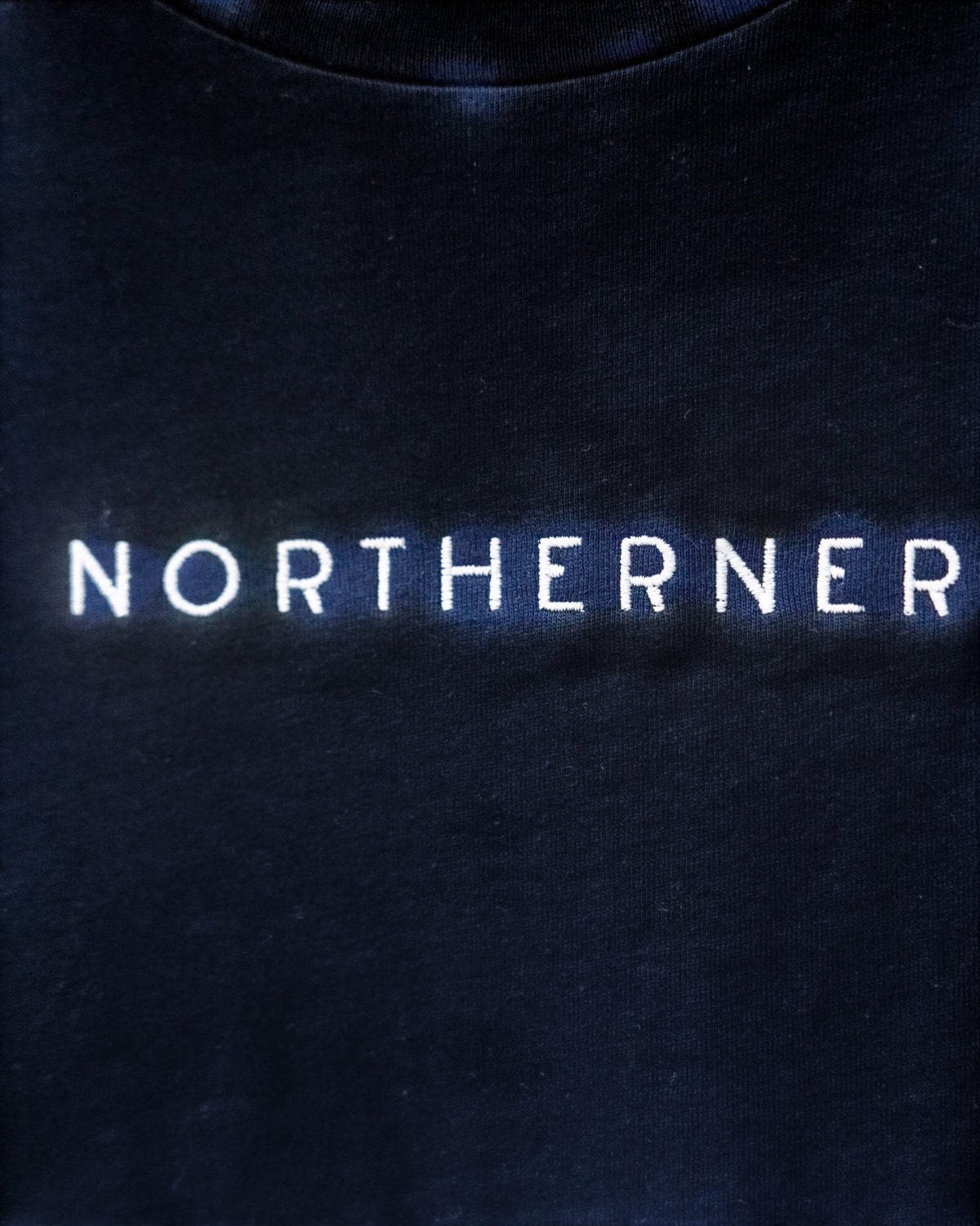 LighthouseLane Northerner embroidered slogan on a dark navy organic cotton t-shirt
