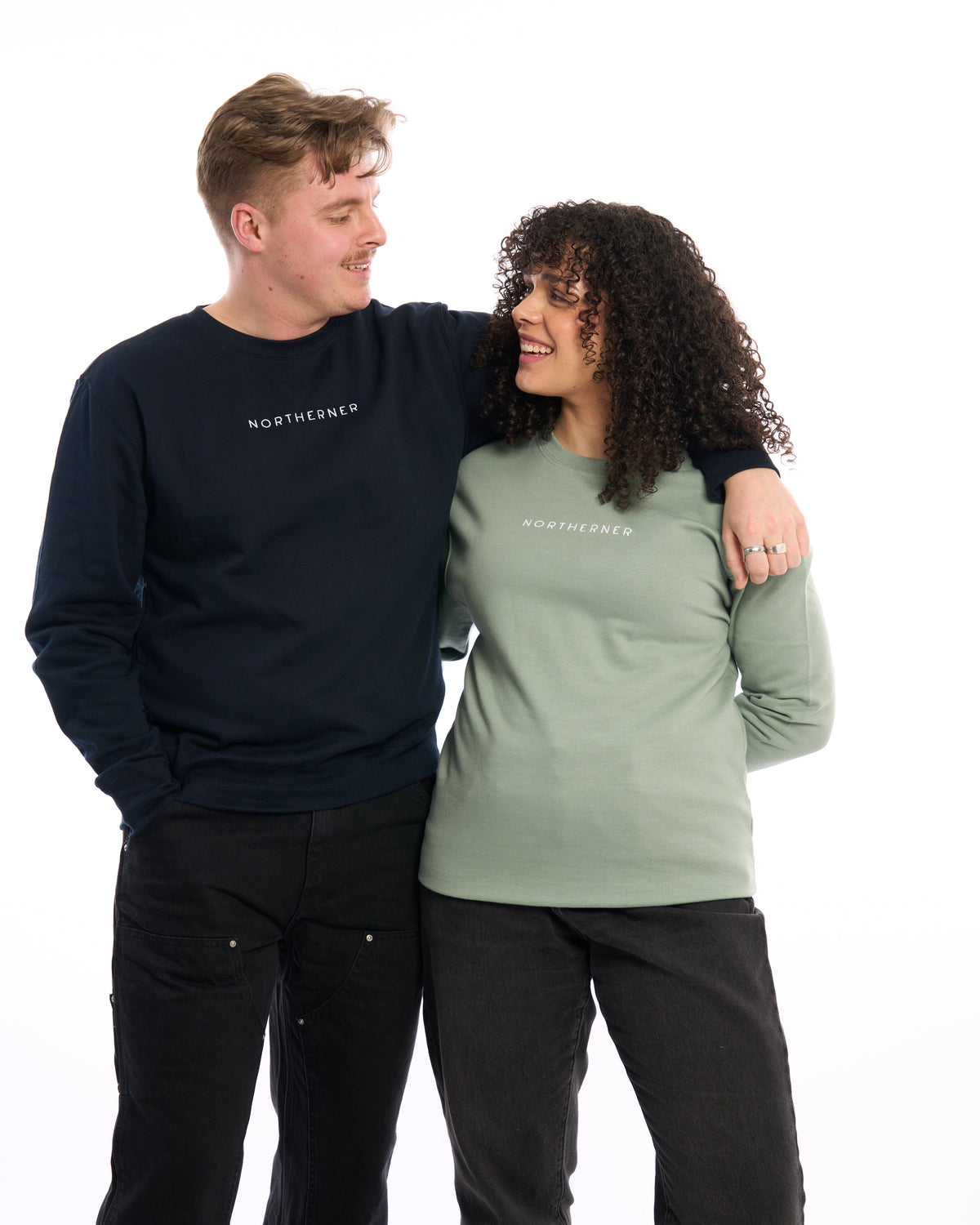LighthouseLane unisex Northerner embroidered sweatshirts in navy and sage green worn by a man and woman.