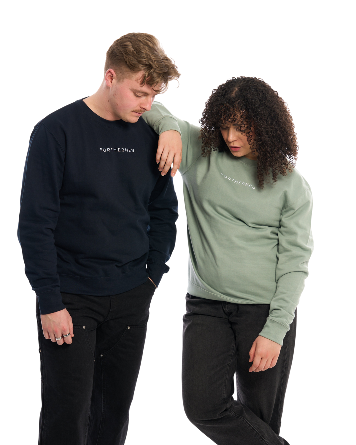 LighthouseLane unisex Northerner embroidered sweatshirts in navy and sage green worn by a man and a woman.