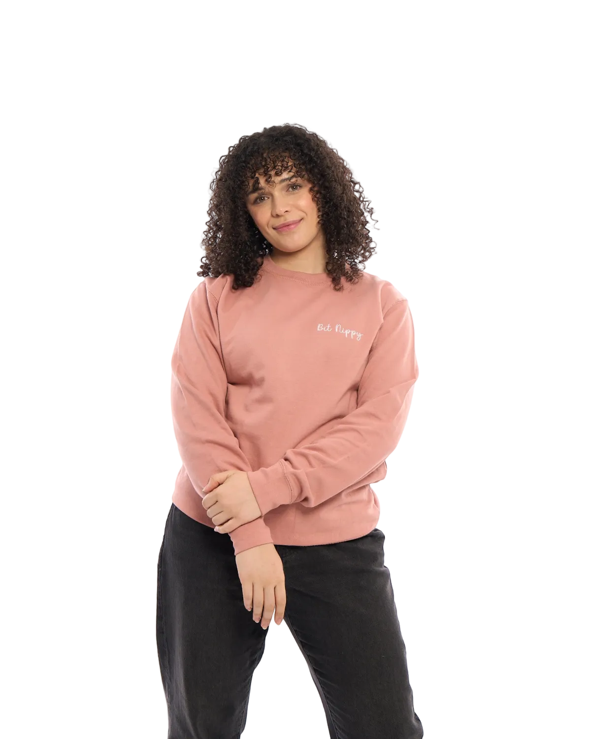 LighthouseLane unisex pink sweatshirt with Bit Nippy embroidery worn by a woman with curly hair against white background