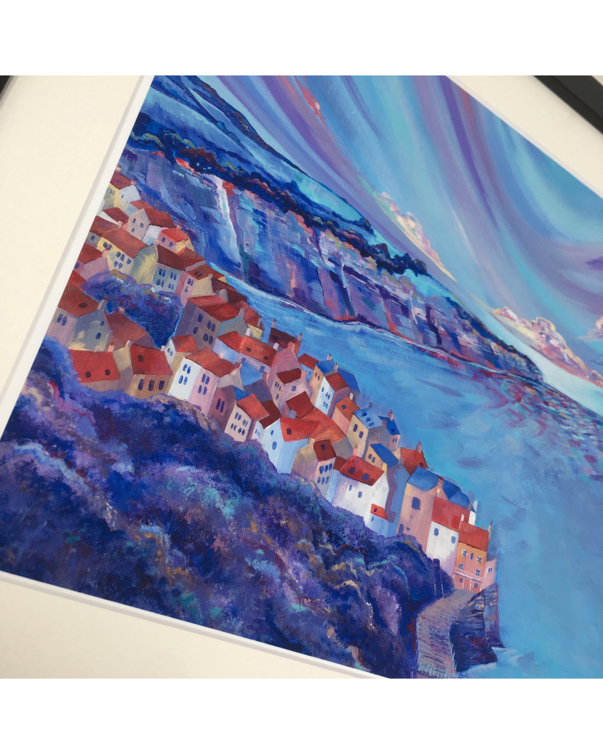LighthouseLane framed art print of Robin Hoods Bay, North Yorkshire, featuring colourful clifftop houses and sea.