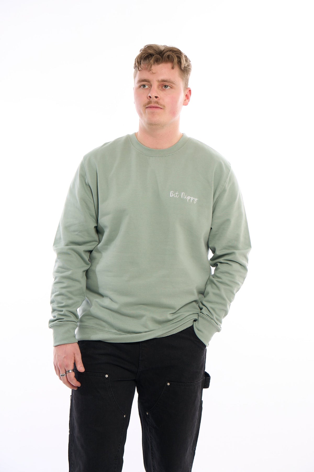 LighthouseLane sage green unisex sweatshirt with Bit Nippy embroidery worn by a man against a white background