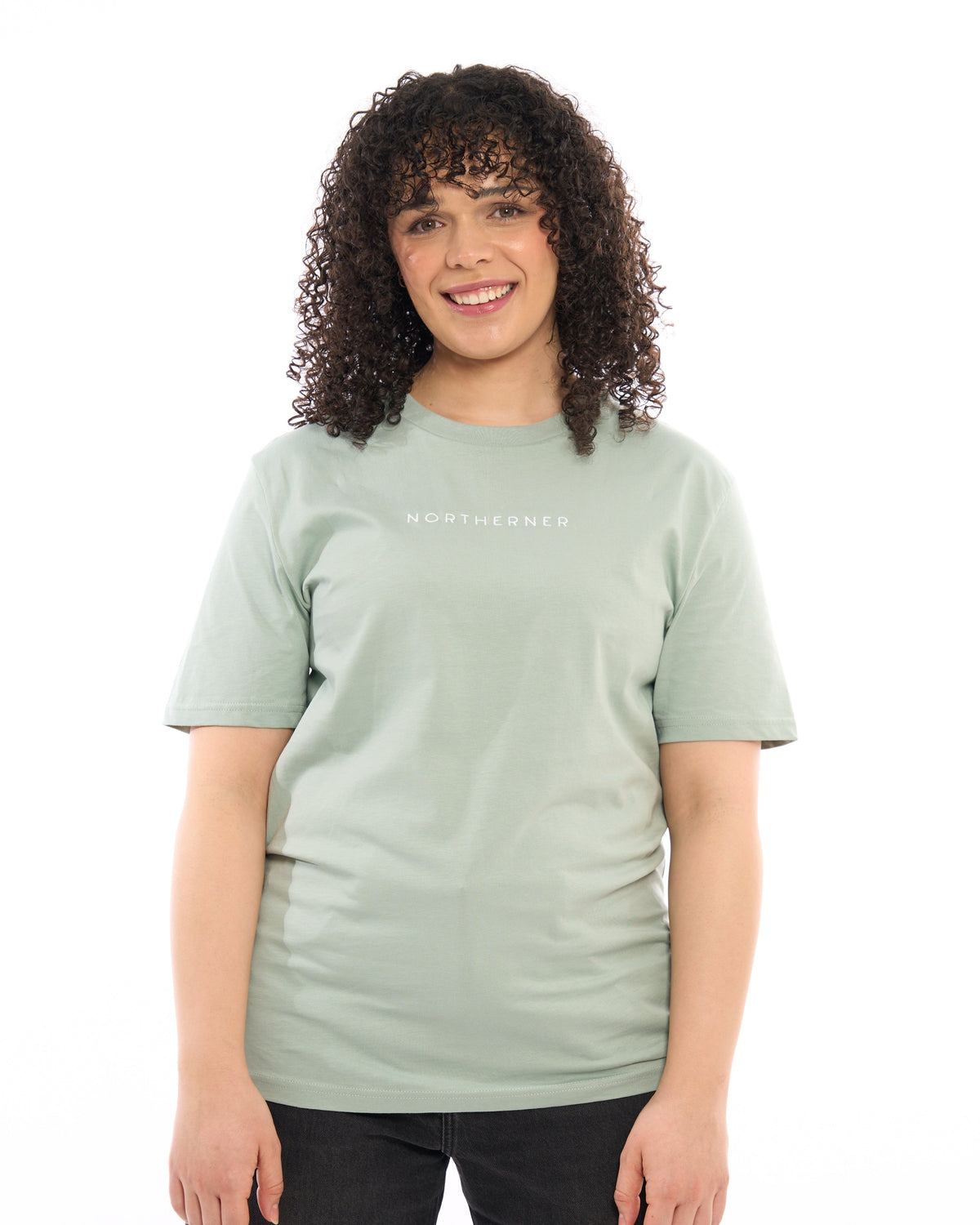 LighthouseLane sage green organic cotton unisex T-shirt with Northerner embroidery worn by a smiling woman