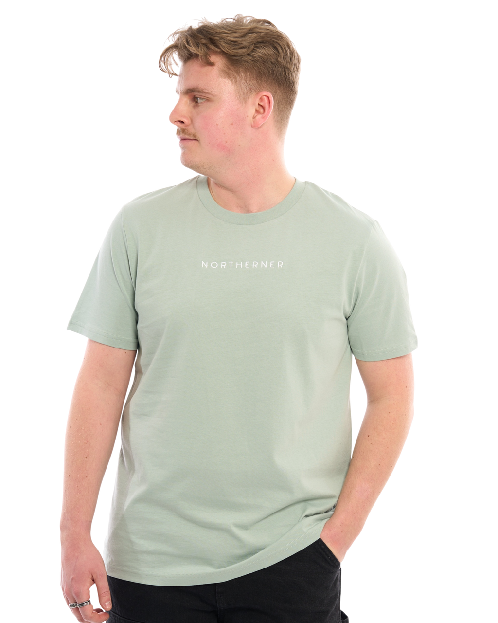 LighthouseLane sage green organic cotton unisex T-shirt with Northerner embroidery worn by a man looking to the side