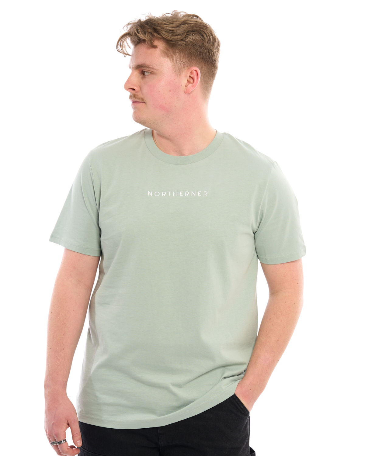 LighthouseLane sage green organic cotton unisex T-shirt with Northerner embroidery worn by a man looking to the side