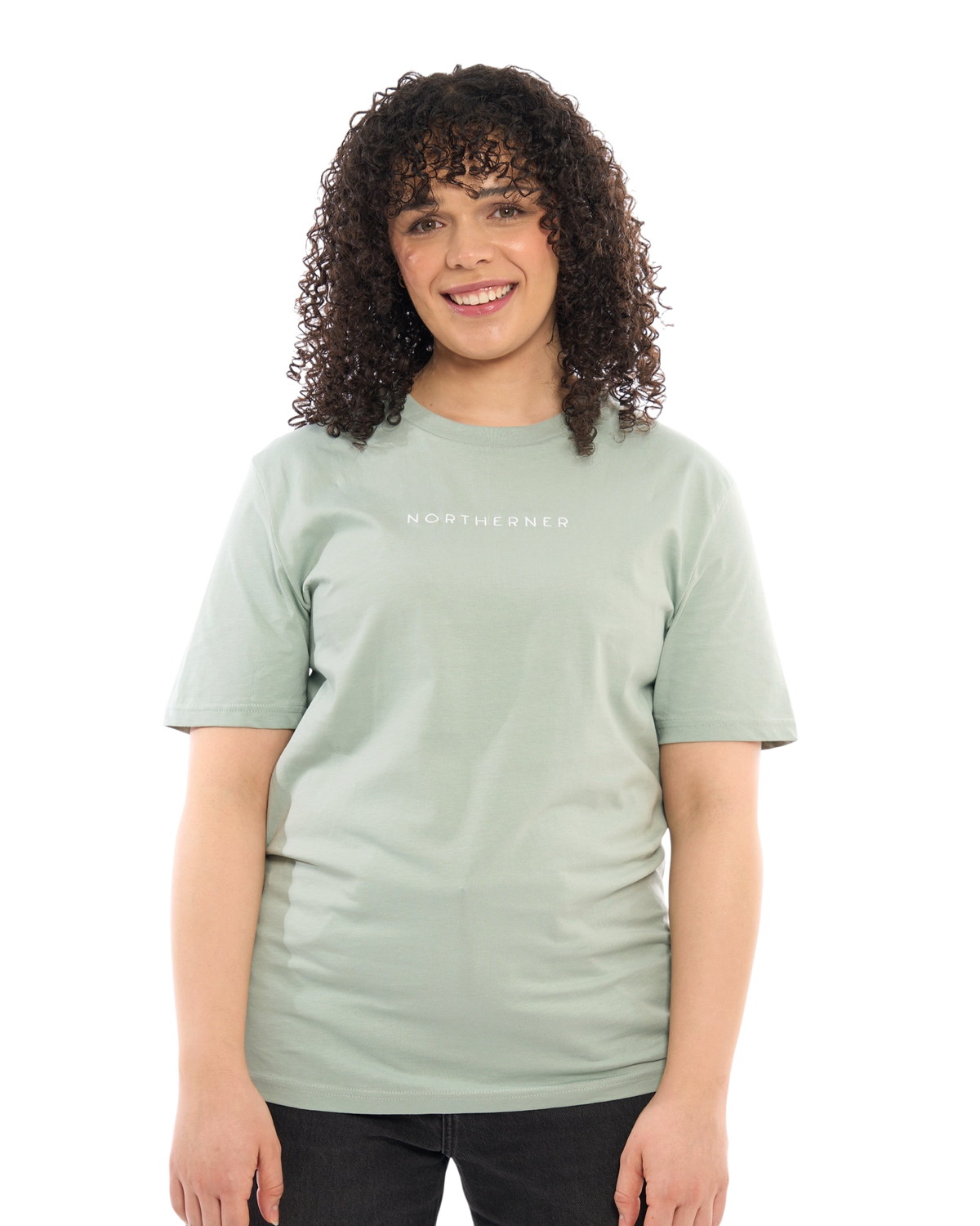 A woman wearing a sage green LighthouseLane Northerner embroidered organic cotton unisex t-shirt on a white background