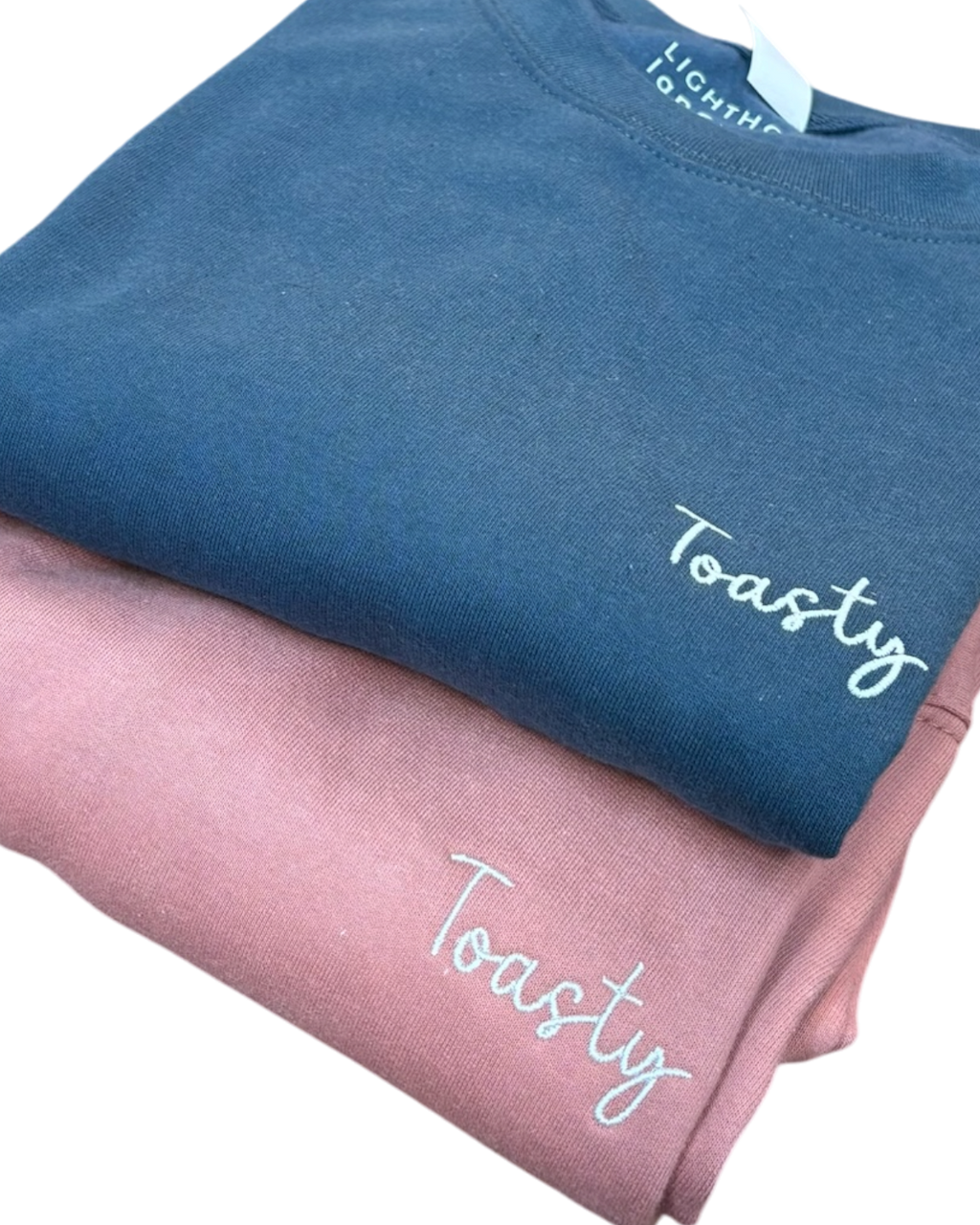 LighthouseLane unisex cotton blend sweatshirts in blue and pink with Toasty embroidered slogan on the chest