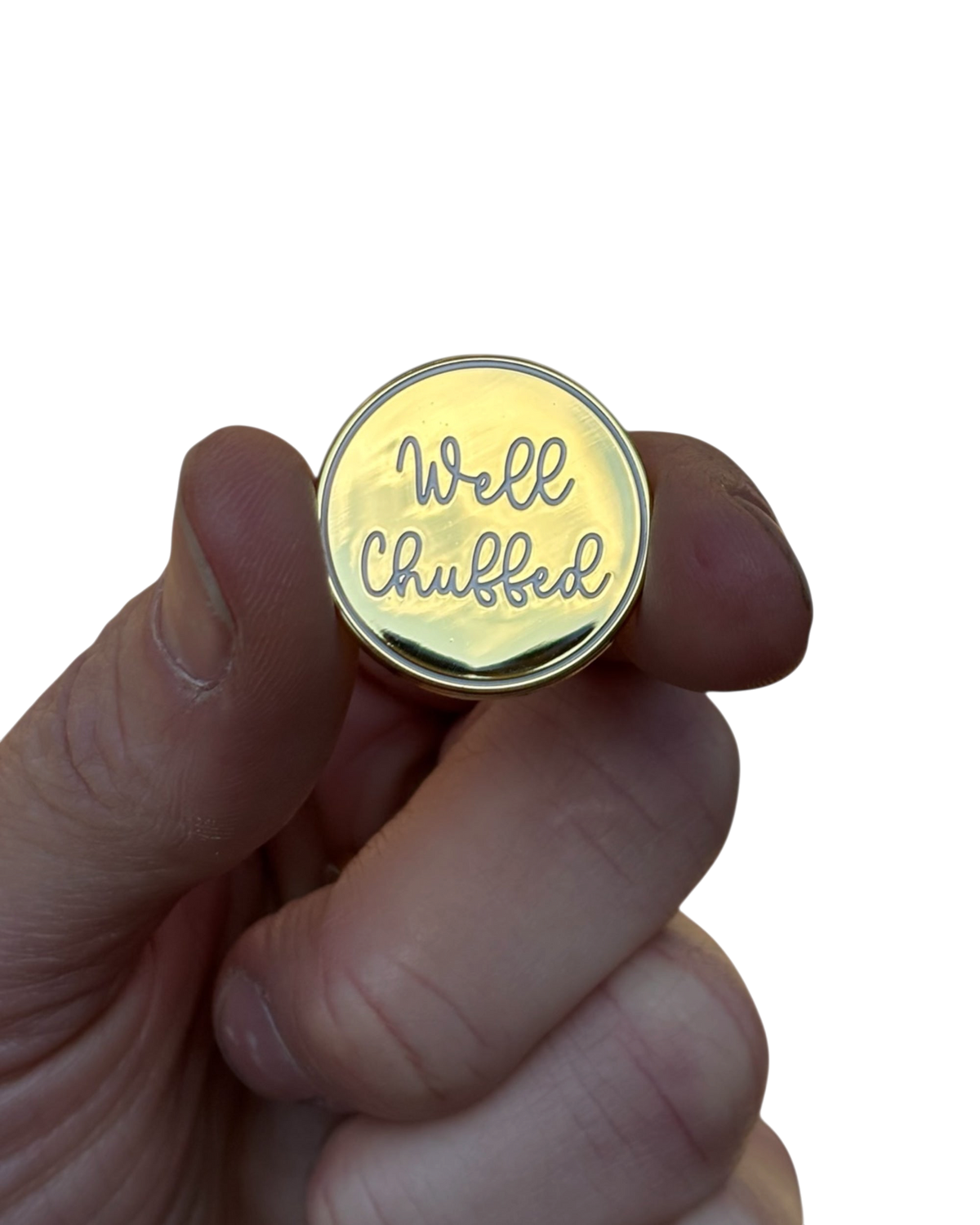 LighthouseLane 25mm gold enamel pin badge with Well Chuffed script text held between fingers