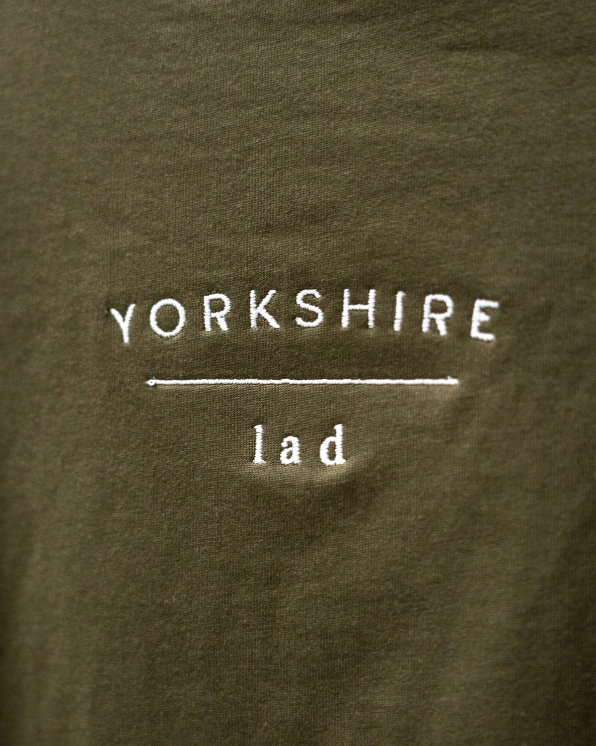 LighthouseLane olive green organic cotton t-shirt featuring white Yorkshire Lad slogan embroidery