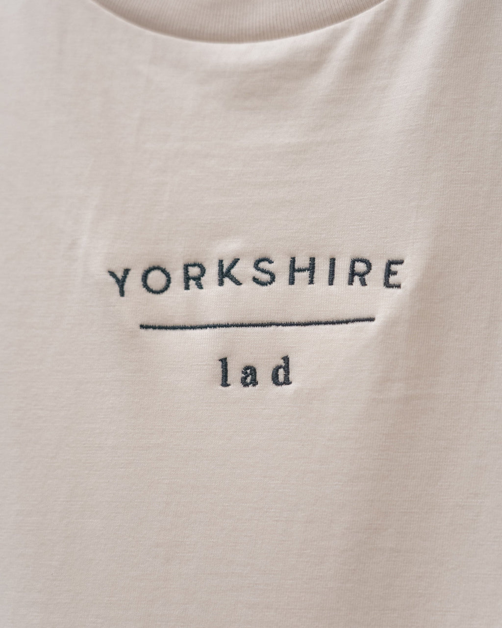 LighthouseLane organic cotton t-shirt in cream featuring Yorkshire Lad slogan embroidered in dark thread