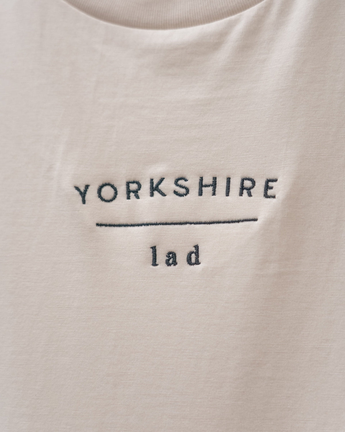 LighthouseLane organic cotton t-shirt in cream featuring Yorkshire Lad slogan embroidered in dark thread