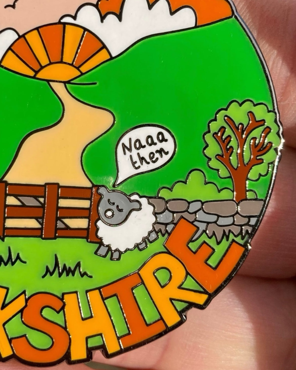 LighthouseLane Yorkshire sheep hard enamel magnet featuring a hand-drawn sheep saying Naaa then in a green landscape