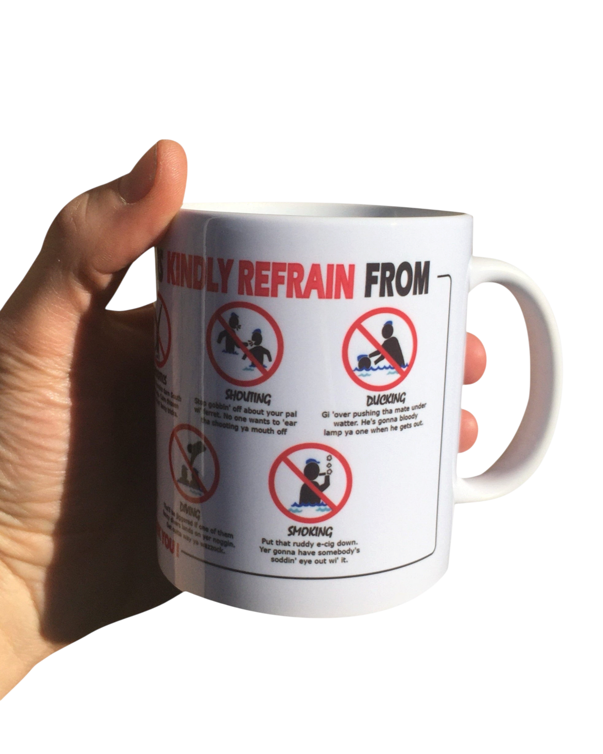 LighthouseLane white ceramic mug featuring a humorous Yorkshire Swimming rules design held in a hand